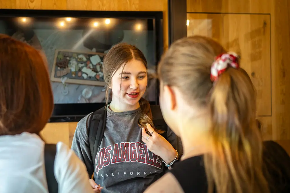 Two teenagers chatting and smiling